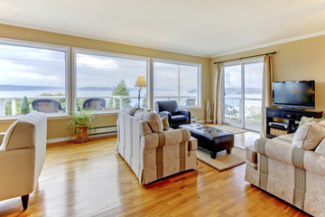 Living room interior with water view and large windows