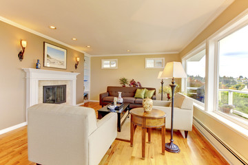 Bright cozy living room with beige walls and fireplace