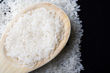 food background. brown rice in a wooden spoon. top view