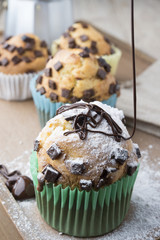 Falling sweet sugar on chocolate muffins