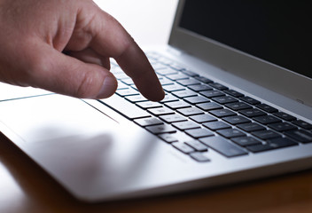 Close Up Of Hand Typing On Laptop Keyboard