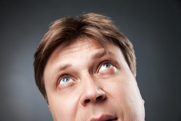 Fototapeta premium Curious adult man looking up
