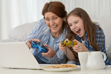 mother and daughter playing computer games