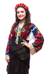 Portrait of cheerful Ukrainian girl wearing national embroidered shirt isolated on white