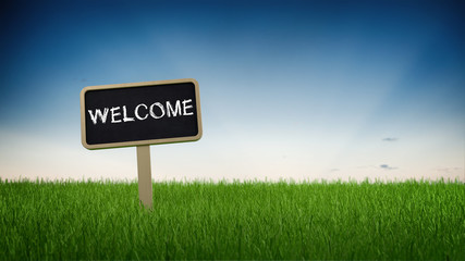 Welcome signboard on a green grassy field