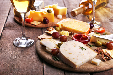 Different kinds of cheese on wooden background