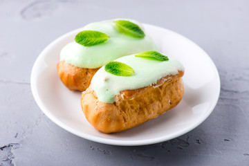 cream dessert eclair with fresh mint leaves