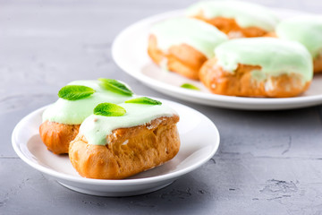 cream dessert eclair with fresh mint leaves