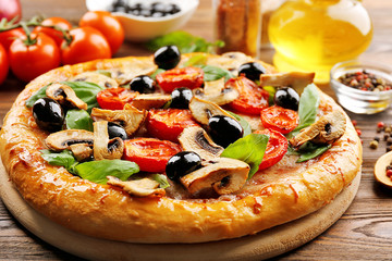 Delicious tasty pizza with ingredients on wooden table