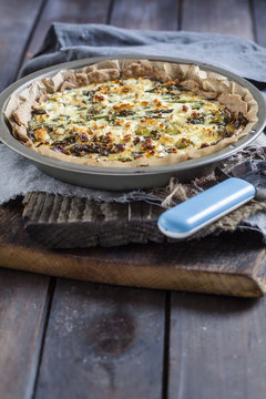 Baking dish of green asparagus tart with feta cheese