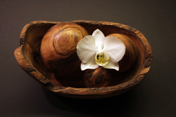 wooden-bowl-with-white-orchid-on-black