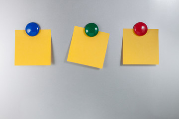 three Post it Note on  refrigerator