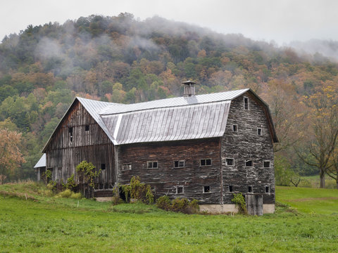 Old Vermont Barn: A large wooden clapboard barn near Tunbridge, Vermont in autumn