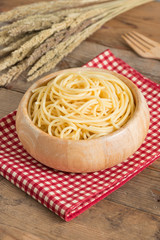 Boiled spaghetti in wood bowl.