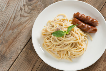 Spaghetti cream sauce chopped mushroom with sausage. Top view.