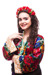 Portrait of cheerful Ukrainian girl wearing national embroidered shirt isolated on white