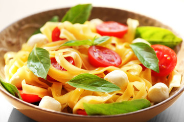 Delicious cold pasta salad in bowl on the table closeup
