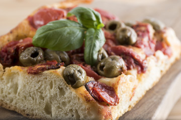 Fresh baked focaccia bread, with olives and tomato pieces. Italian Pizza