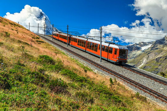 Electric tourist train and famous misty Matterhorn peak,Switzerland,Europe