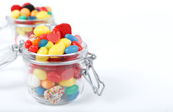 Colorful candy and gum in the glass jar
