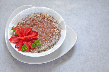 Chocolate oatmeal decorated with strawberry flower