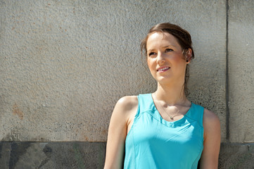 Fit woman resting after run in the city. Jogger.