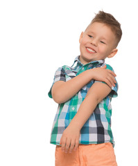 A little blond boy with a fashionable hairstyle on his head, a plaid shirt and orange shorts fun laughs - Isolated on white background