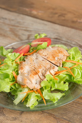 Fresh salad with grilled chicken breast, lettuce and tomato.