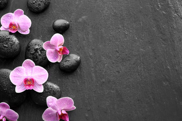 Fototapeta na wymiar Spa stones and orchids on dark background