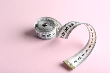 Measuring tape  on pink background