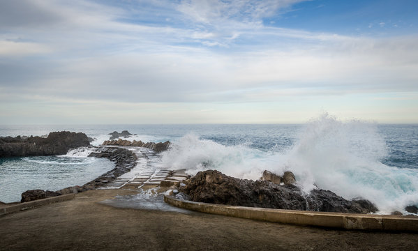Waves splashing of pier to the Atlantic ocean in Seixal, Madeira island
