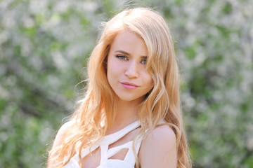 Young beautiful woman on blooming tree background