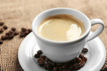 Cup of coffee on tablecloth