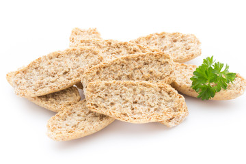 Dry flat bread crisps with herbs on a white background.