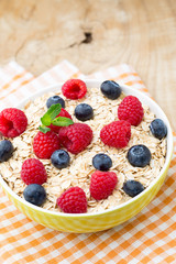 Oatmeal porridge with berries. Raspberries and blueberries.
