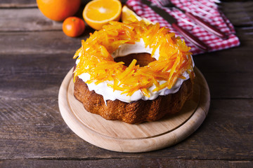 Delicious citrus cake on wooden background