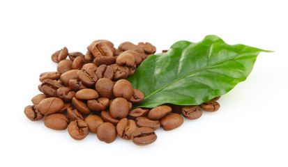 Coffee beans and green leaves, isolated on white