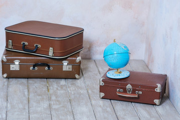 Travel background concept with old fashioned suitcases and global map
