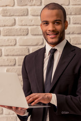 Afro American businessman with gadget