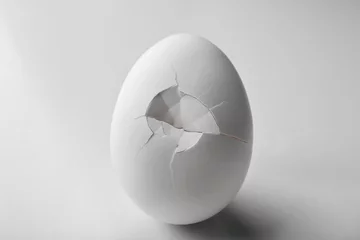 Rolgordijnen Cracked egg on white background © Africa Studio