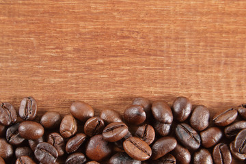 coffee beans on the brown wooden background