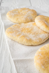 Pita on a napkin at the edge of the table