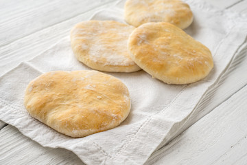 Pita, napkin on white wooden boards diagonal