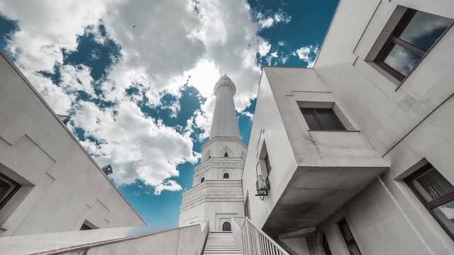 The sun breaks through the clouds over a white mosque. Kazakhstan - 4K Timelapse