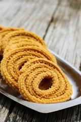 Fototapeta na wymiar Murukku - Crunchy savory iondian snack, selective focus