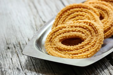 Murukku - Crunchy savory iondian snack, selective focus
