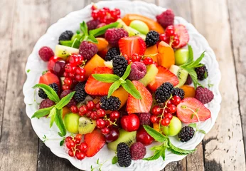 Deurstickers Fresh fruit salad on the plate © pilipphoto