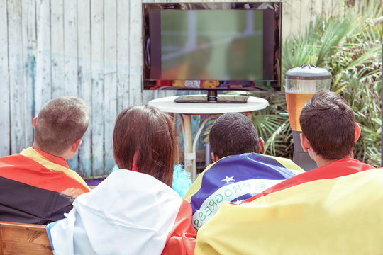 Young football supporter fans watching soccer match 