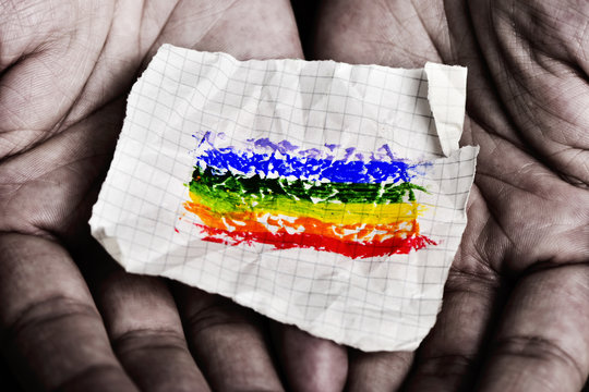 man with a piece of paper with a rainbow flag