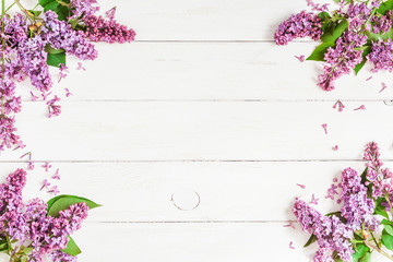 lilac flowers on white wooden background, top view, flat lay